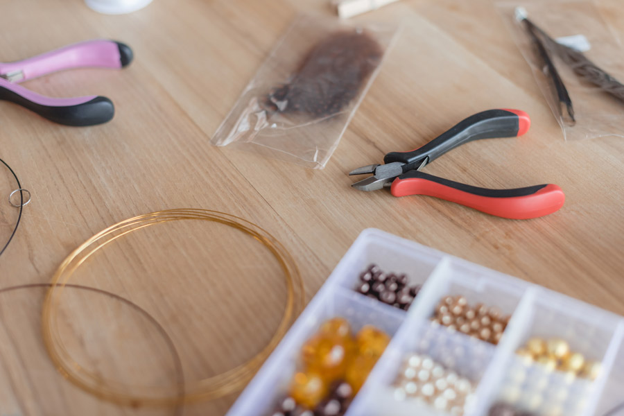 A collection of tools, beads and wire for making jewellery