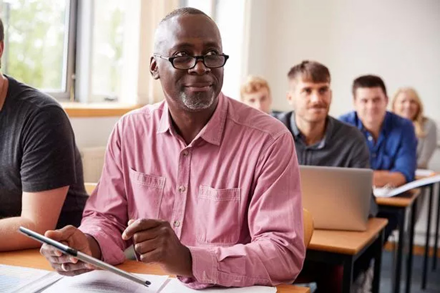 People sitting at desks in a class