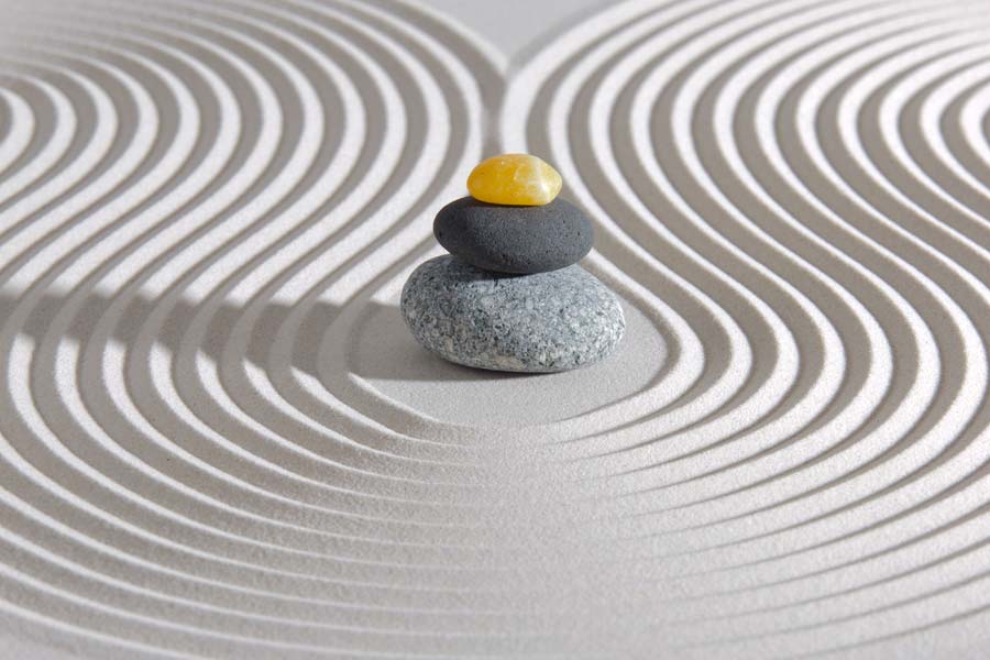 stacked stones in sand zen garden
